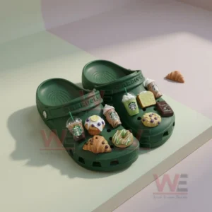 Starbucks green Crocs with drink and pastry charms placed on light background under soft lighting!