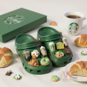 Green Starbucks Crocs with coffee and dessert themed charms beside branded box and pastries on white surface!