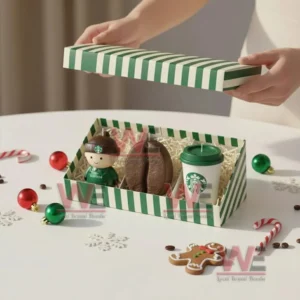 Starbucks Premium Shaped Candle Set 5 Open gift box with barista candle coffee bean candle and cup candle surrounded by holiday decorations.