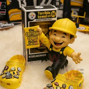 Worker toy figure holding a fiftieth anniversary towel beside a display box and decorated yellow shoes.
