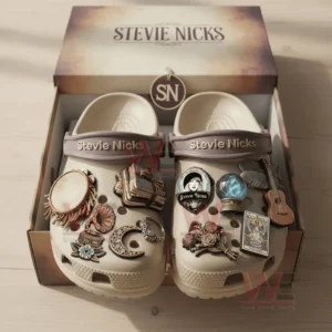 Beige clogs with Stevie Nicks decorations including musical and moon-themed charms inside a gift box.