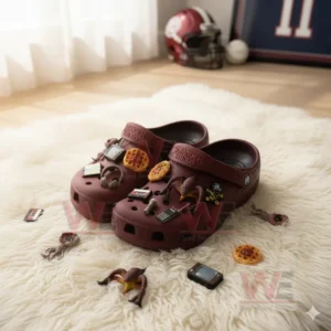 Maroon Stranger Things Crocs with themed charms like waffles and cassette tape on white furry rug!