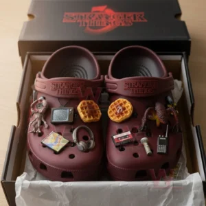 Maroon Stranger Things Crocs with show inspired charms inside box on light surface!