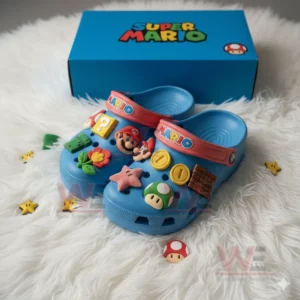 Blue Super Mario Crocs with themed charms and matching box displayed on white furry rug!