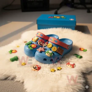 Blue Super Mario Crocs with colorful game charms placed on white rug near blue box!