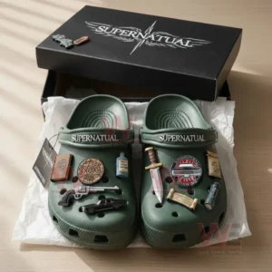 Supernatural Crocs Clogs with Charms 7 Green Supernatural clogs with detailed charms placed in a black box on a wooden table.