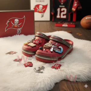Red Tampa Bay Buccaneers Crocs with football and pirate themed charms displayed on white rug!