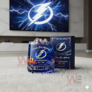 A Tampa Bay Lightning themed glass and box placed on a white rug with a television showing a lightning emblem behind them.