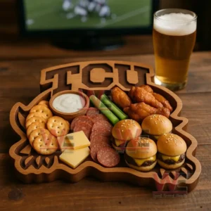 A closeup display of a wooden snack board filled with game day foods including sliders wings sliced meats cheese crackers celery and dipping sauce!