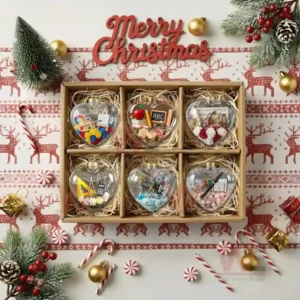 Alt text: Heart-shaped Christmas ornaments with teacher-themed items like books, pencils, and ABC blocks.