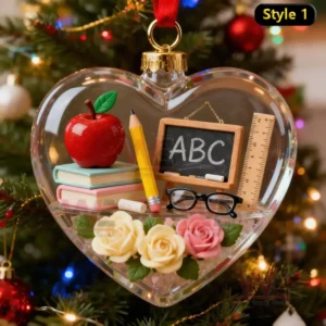 Alt text: Heart-shaped ornament filled with educational items like books, an apple, and a pencil.