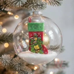 A clear ornament containing a Ninja Turtles themed Christmas stocking resting on snow!