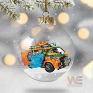 A clear ornament containing a bright turtle themed van set over a snowy surface with winter lights behind it!