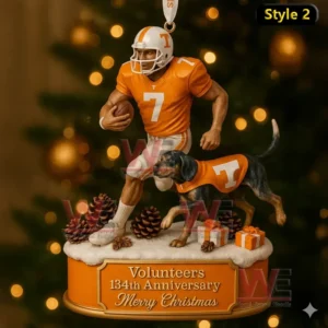A Tennessee Volunteers ornament with a number 7 player running beside a dog in an orange T jersey on a snow covered base.