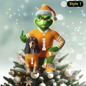 Tennessee Volunteers x Grinch Christmas Tree Topper 6 The Grinch and his dog wearing orange Tennessee Volunteers jerseys and Santa hats standing together on top of a Christmas tree covered in snow and ornaments!