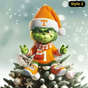Tennessee Volunteers x Grinch Christmas Tree Topper 7 A small Grinch wearing an orange Tennessee Volunteers sweater scarf and Santa hat sitting on a snowy Christmas tree decorated with white ornaments!