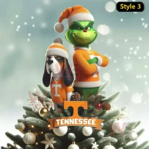 Tennessee Volunteers x Grinch Christmas Tree Topper 8 The Grinch and his dog wearing orange Tennessee Volunteers outfits and Santa hats standing proudly on a Christmas tree decorated with white ornaments and pinecones with a Tennessee logo at the base!