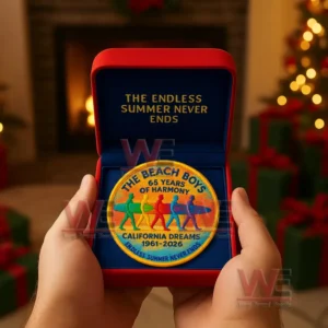 The Beach Boys anniversary patch in a red box held near Christmas decorations.