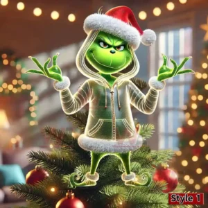 The Grinch in a Santa hat posing playfully on a decorated Christmas tree with warm festive lights in the background!