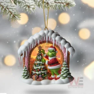 Snowy cave ornament with green Santa character beside a decorated Christmas tree.