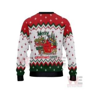 The back of a Grinch themed Christmas sweater showing a sleigh full of gifts and festive artwork!