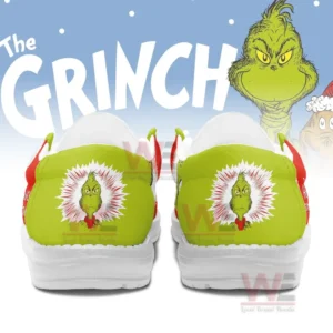 Back view of Hey Dude shoes with Grinch face design in green and red colors.
