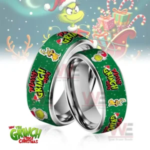 Two silver rings with green Merry Grinchmas themed bands in front of a festive backdrop!