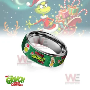 Silver ring with green Merry Grinchmas themed band before a festive sleigh background!