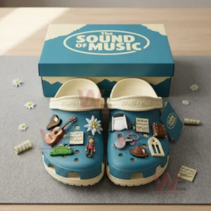 Blue and cream The Sound of Music clogs in a box with multiple themed charms.