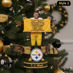 The Terrible Towel 1975-2025 Ornament 4 An athlete holding a yellow towel stands on a round ornament hanging from a Christmas tree decorated with gold and black baubles.