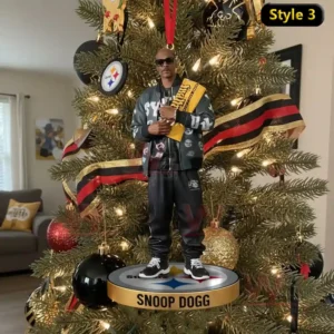 The Terrible Towel 1975-2025 Ornament 5 A man wearing sunglasses and holding a yellow towel stands on a round ornament hanging from a Christmas tree decorated with red black and gold ornaments.