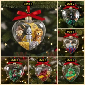 A set of Christmas ornaments showcasing various Wizard of Oz characters and settings each placed inside a transparent heart shaped globe with detailed miniature decorations!