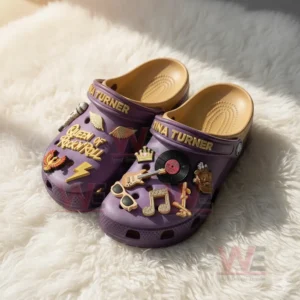 Purple Tina Turner Crocs with gold lettering and musical charms including microphone, guitar, and vinyl record.