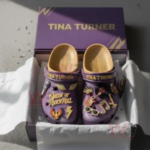 Boxed purple Tina Turner Crocs with golden accents and rock music themed charms.