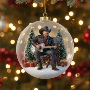 Toby Keith Christmas Ornament 11 A Christmas ornament featuring Toby Keith seated with a guitar inside a transparent globe with winter themed decorations!
