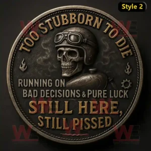 Dark silver biker coin with skull design and engraved bold text expressing strength and defiance!