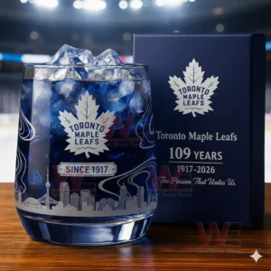 Toronto Maple Leafs 109th Anniversary Whiskey Glass 3 A Toronto Maple Leafs anniversary whiskey glass with ice next to a branded gift box in a stadium environment.