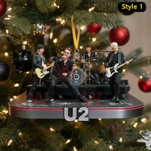 A full band ornament showing four performers on a platform hanging before a Christmas tree.