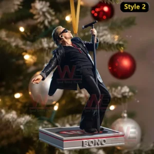 A singer ornament leaning back while holding a microphone stand in front of a Christmas tree.