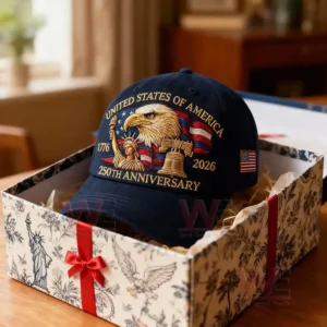 A blue anniversary cap rests inside a decorated gift box with patriotic designs.
