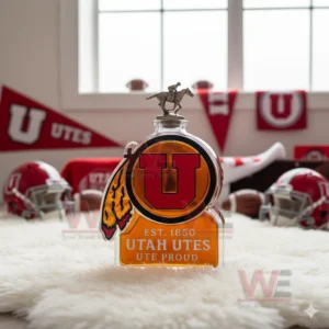 A Utah Utes logo shaped bottle sits on a white rug with red helmets and banners behind it!