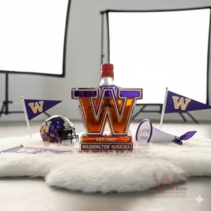 A W shaped Huskies bottle sits on a white rug with team flags a helmet and a megaphone behind it!