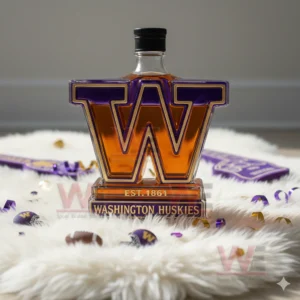 A W shaped Huskies bottle sits on a white rug with confetti mini footballs and purple and gold fan items nearby!