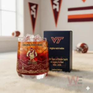 A Virginia Tech Hokies themed iced drink glass next to a dark anniversary box in a sports decorated room!