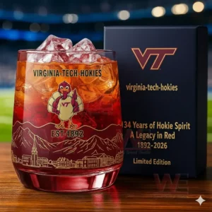 Virginia Tech Hokies 1892-2026 134th Anniversary Whiskey Glass 5 A Virginia Tech Hokies themed iced drink glass beside a display box with a lit stadium in the background!