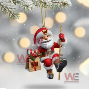 Washington Commanders Santa ornament hanging from a snowy tree branch with gift bag and rope.