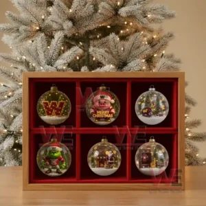 A display of six Washington Commanders Christmas ornaments featuring Santa and football themed designs in a wooden case before a Christmas tree.