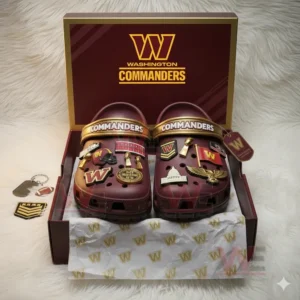 Maroon Washington Commanders Crocs with golden and red charms inside a themed box.