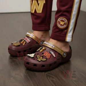 Person wearing maroon Washington Commanders Crocs with golden charms and matching logo pants.