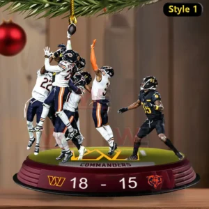 Football players leaping to contest a pass on a display base used as a Christmas ornament.